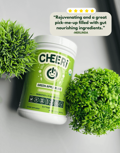 CHEERi Green Apple Bliss Elixir with green plants, highlighting gut health and revitalizing benefits.